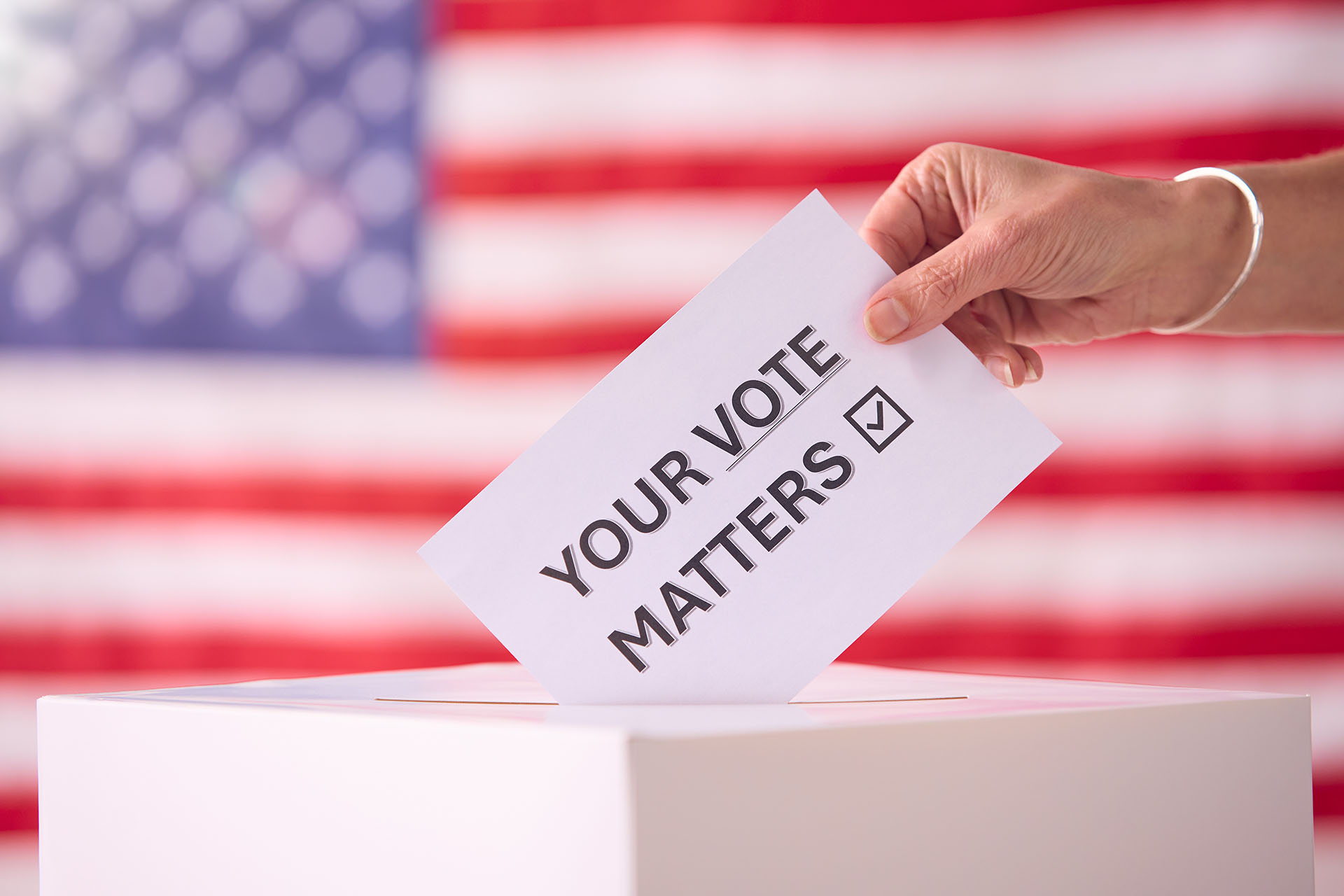 hand-placing-ballot-in-box