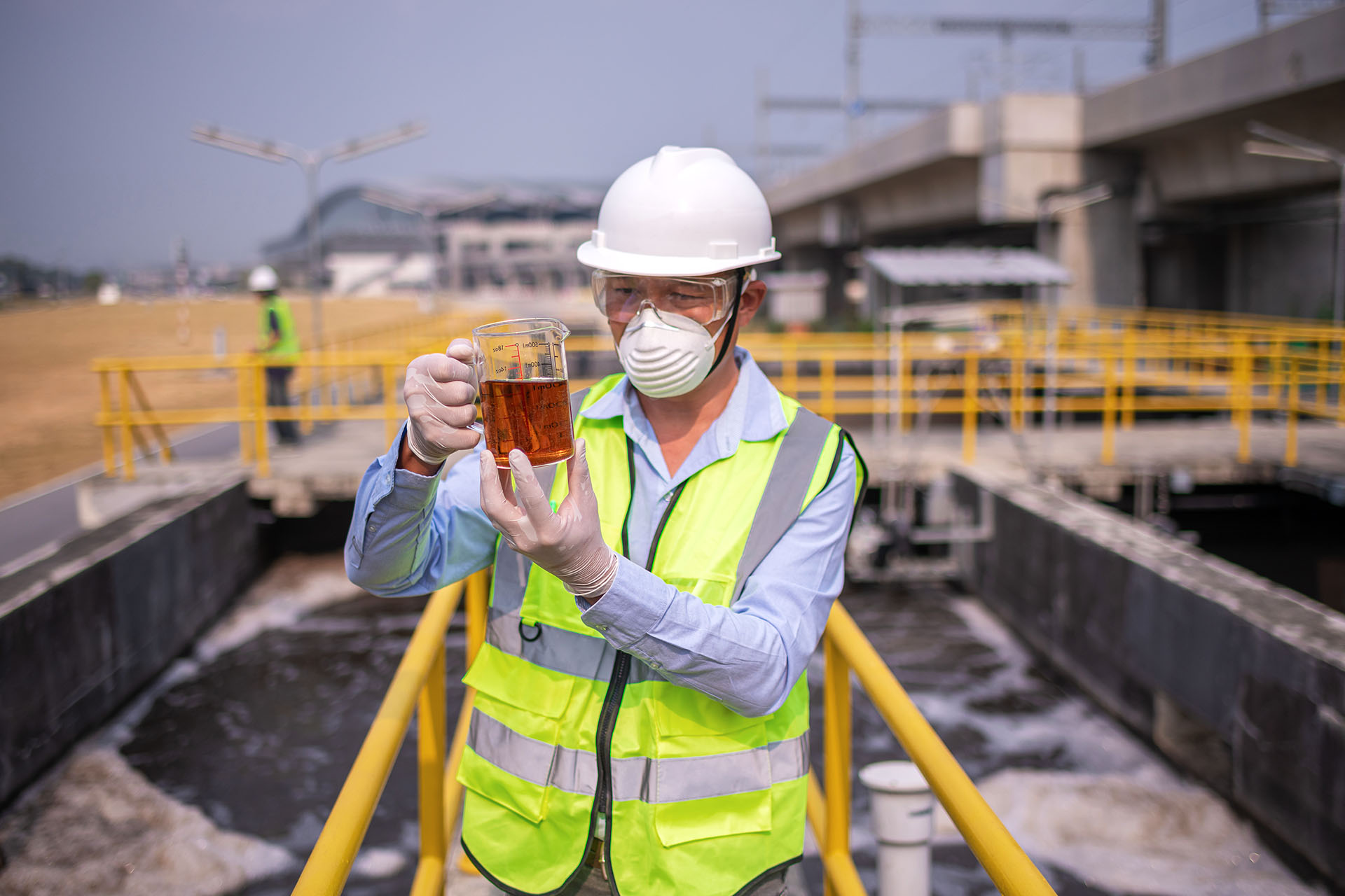 engineer-take-water-from-wastewater-treatment-pond